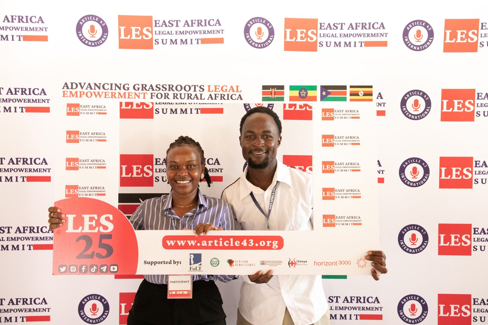 Attendees at the LES25 photo backdrop